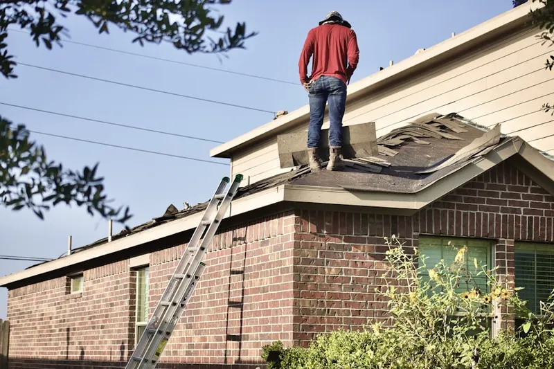 Professional roofer working on a residential roof in Mt. Pisgah